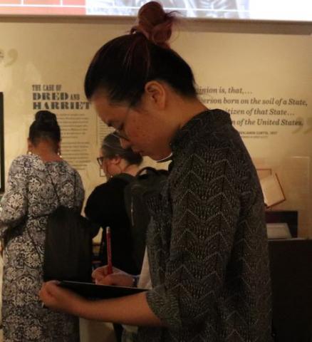 Celia Shao taking notes at a museum