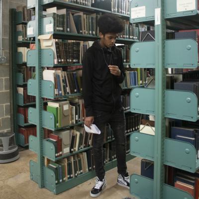 Student standing in the archive